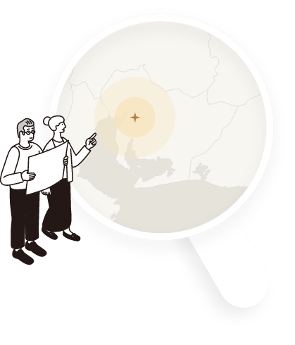 虫眼鏡の中に地図が入っていてそれを指さしている女性と男性